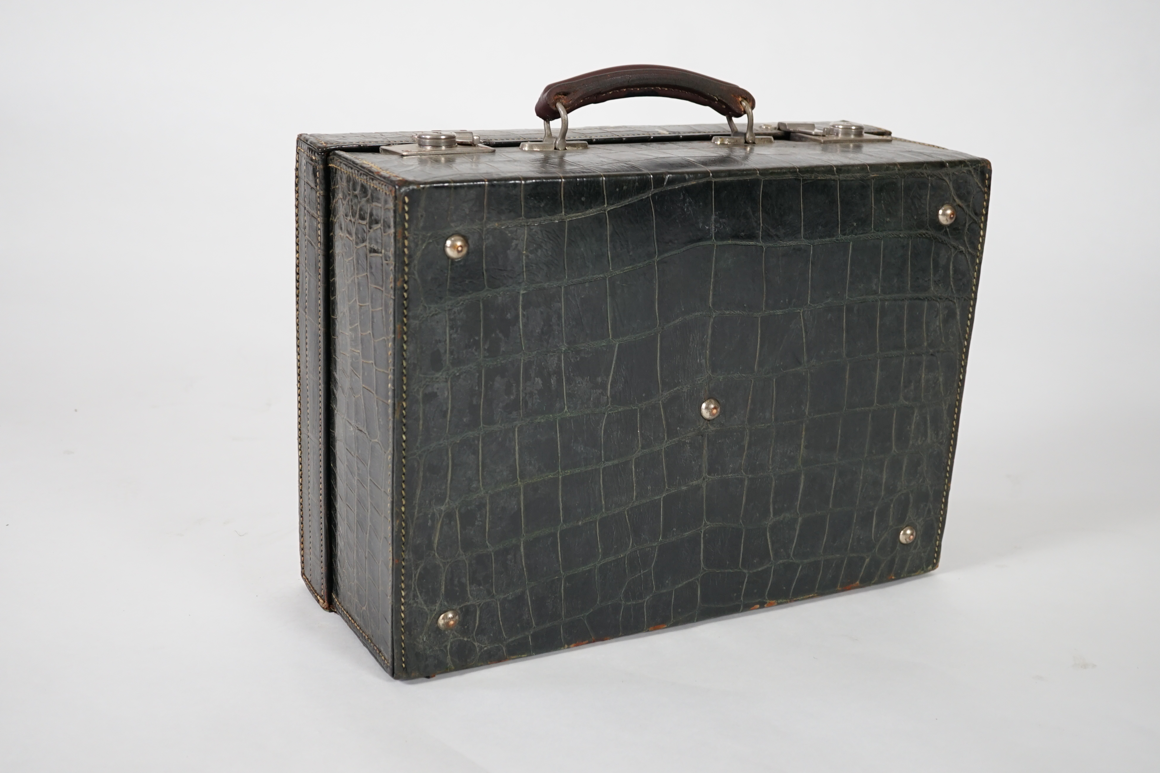 A George V green crocodile toilet case, 46cm x 33cm x 18cm